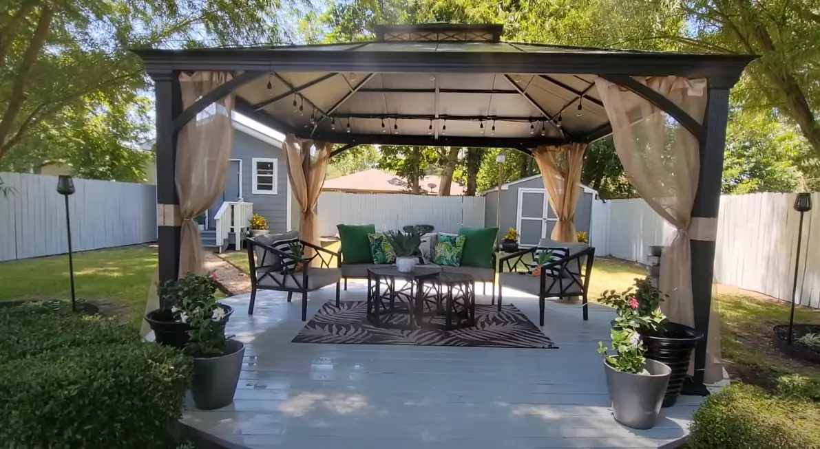 Image of a gazebo expertly anchored with planters, showcasing an innovative and stylish approach to ensure stability and enhance outdoor aesthetics. Learn how to anchor a gazebo using planters and create a secure and visually appealing space for relaxation and entertainment.